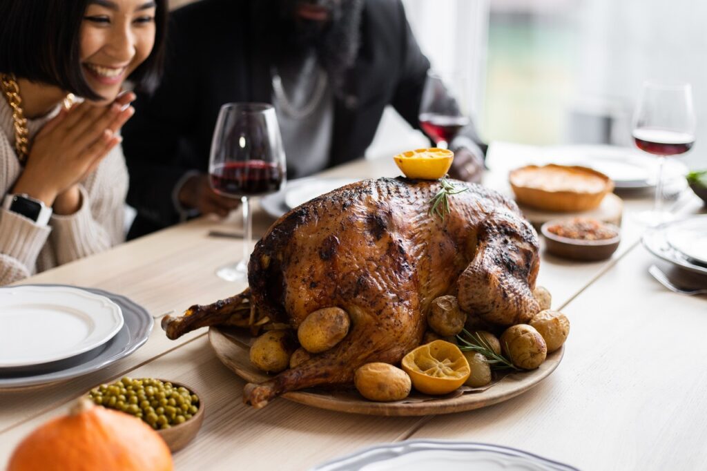 Woman looking at the turkey served on the table