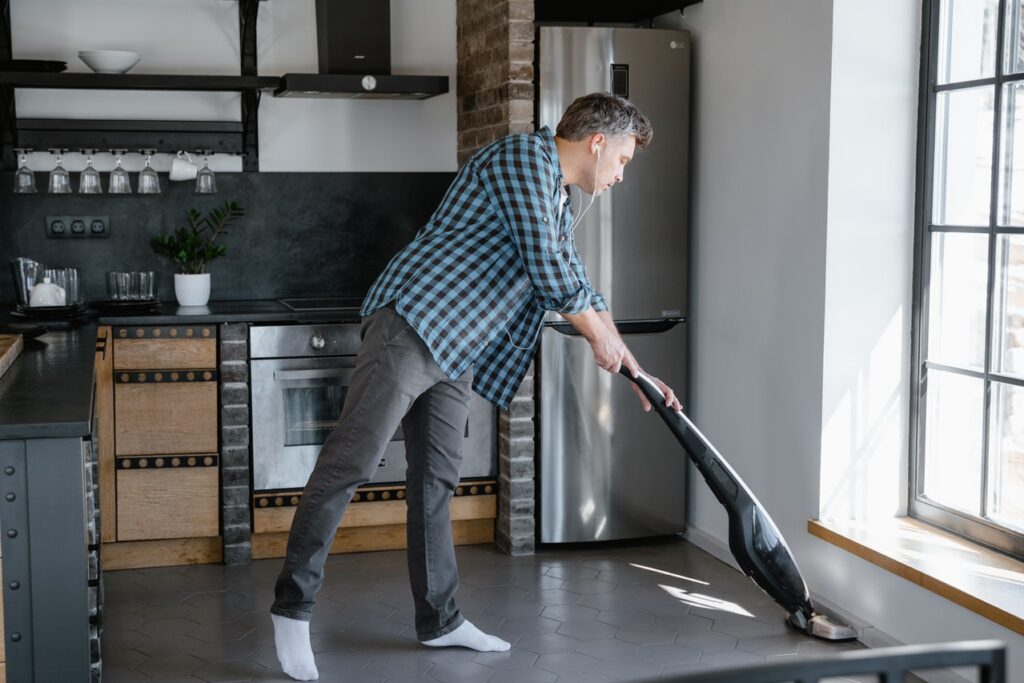 Man vacuuming the floor