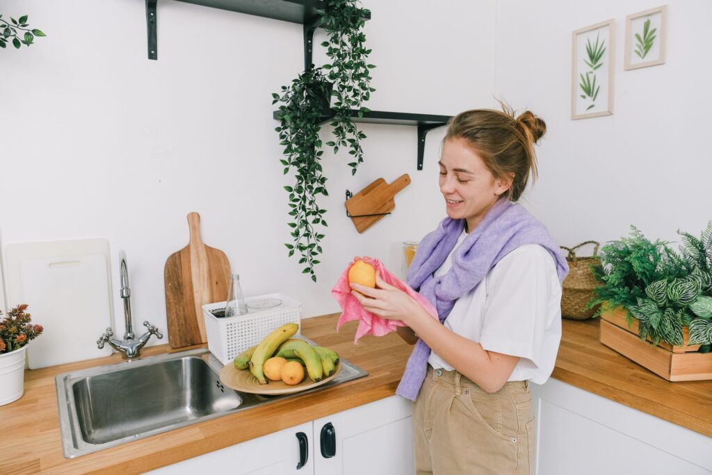 A woman cleaning an orange